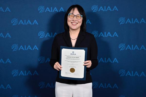 Alicia Kim holding award.